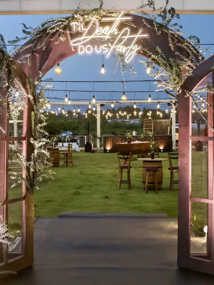 Let the party begin. We designed this rustic-chic Mehendi entrance with a playful neon sign, "Til Death Do Us Party," setting a fun and modern tone for the celebration. It’s the perfect welcome for an evening of joy and dancing.