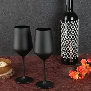 We create sophisticated lifestyle images for premium products. This shot uses moody lighting and a simple, elegant composition to highlight the modern design of these matte black wine glasses, making them desirable for discerning customers.