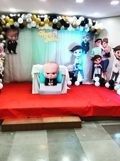 A fun 'Boss Baby' birthday stage with unicorn and rainbow props. This shows how I can combine different themes to create a unique party for your child.