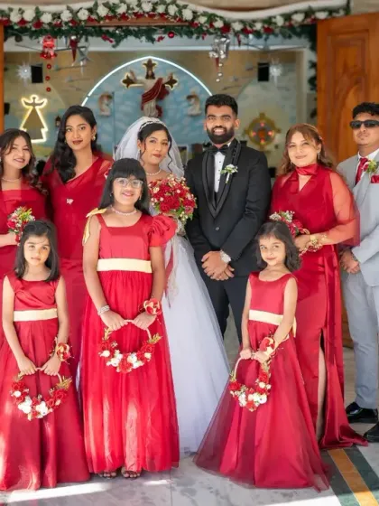 The complete wedding party. A beautiful family portrait outside the church, capturing the couple with their bridesmaids, groomsmen, and adorable flower girls.
