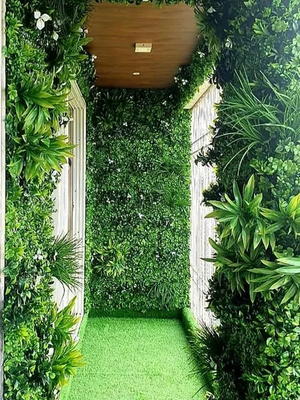 Even the narrowest of balconies can become a lush escape. For this client, we covered the floor, walls, and even the ceiling entrance with a combination of artificial turf and vertical garden panels for a fully immersive green experience.