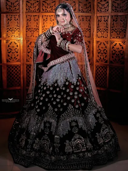 A full-length shot of the bride, showcasing the unique doli motif embroidery on her velvet lehenga.