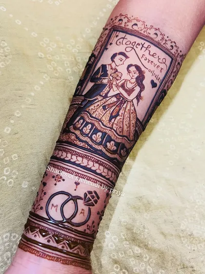 This is one of my favourite bridal pieces. It tells a complete story on the arm, with a custom portrait of the couple, their engagement date, and intertwined wedding rings with their initials. This is the kind of personal, detailed work I love to create for a bride's special day.