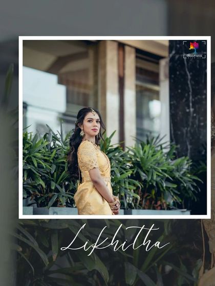 A stylish portrait of Likhitha. The modern architectural background complements her elegant golden saree, creating a chic and contemporary look.