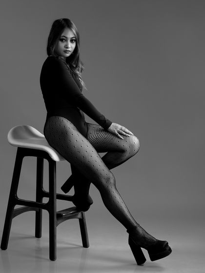 A black and white version of a seated pose, creating a timeless and sophisticated image.