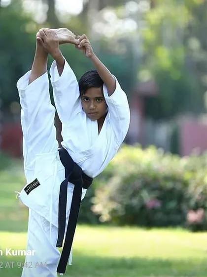 My little brother showing incredible flexibility with a standing split. We teach children proper stretching techniques from a young age to build a strong, flexible foundation for their karate journey.