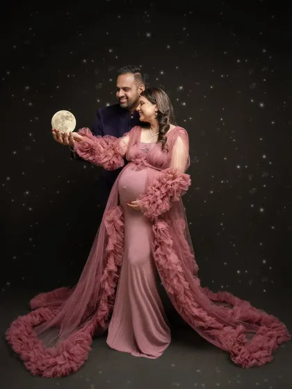I believe in creating magic. For this celestial-themed maternity portrait, we brought the moon down from the stars to celebrate the universe of love this couple is creating. It’s a blend of fantasy and the very real joy of expecting.
