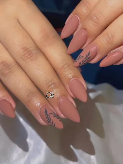 A full view of the matte nude set with a delicate black leaf design.