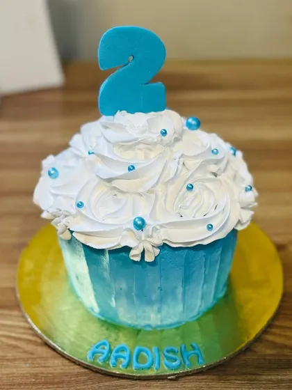 A blue giant cupcake cake for a 2nd birthday.