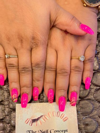 A vibrant set of hot pink square nails. The accent nails feature a subtle, multi-colored striped pattern for a fun, artistic touch.