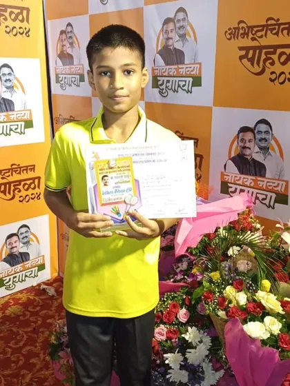 Mayuresh holding his certificate after becoming the runner-up in the U-15 Boys Singles at the Raigad District Badminton Tournament.