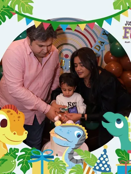 A sweet family moment during the cake-cutting at a dinosaur-themed party. These are the precious memories that we strive to help create for every family.