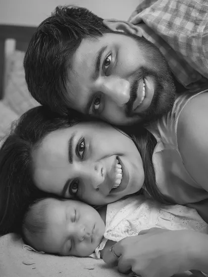 A perfect family cuddle. This black and white newborn portrait captures the pure joy and peace of a family of three, lost in their own little world.