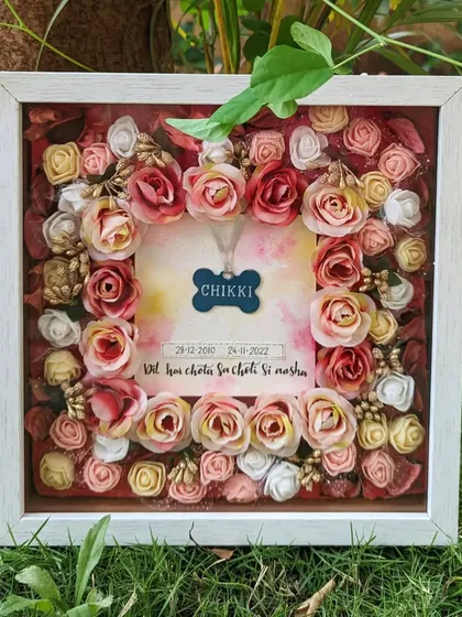 This floral shadow box was created to preserve a beloved pet's memory forever. I designed it to hold the pet's locket, surrounded by handcrafted flowers, making it a deeply personal and beautiful keepsake.
