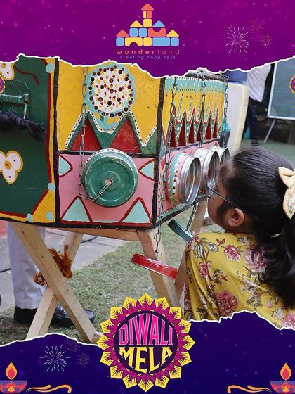 A child peers into a bioscope, a classic feature at our Diwali Mela. We love blending traditional entertainment with modern festivities, offering children a unique glimpse into the past.