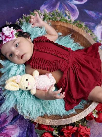 Cuddling with her bunny friend, this little one shows off her sweet side during her two-month milestone photoshoot.