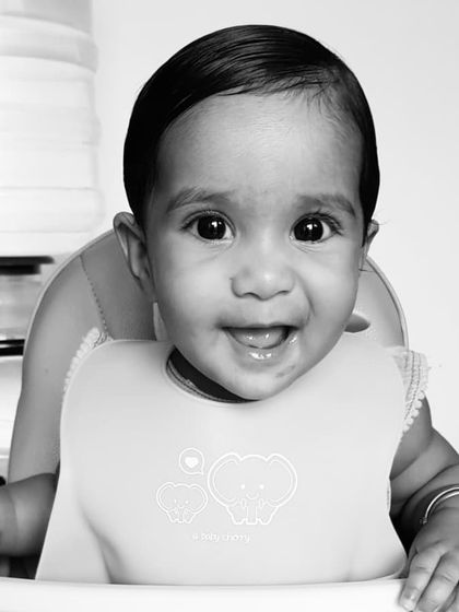 A happy smile from my little one during her first year. Learning to self-feed gave her so much independence and made introducing new foods a fun experience for both of us.