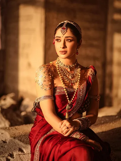 A serene portrait of Nyra Banerjee, capturing a pensive mood. The lighting and composition give this image a painterly quality, reminiscent of old royal portraits.
