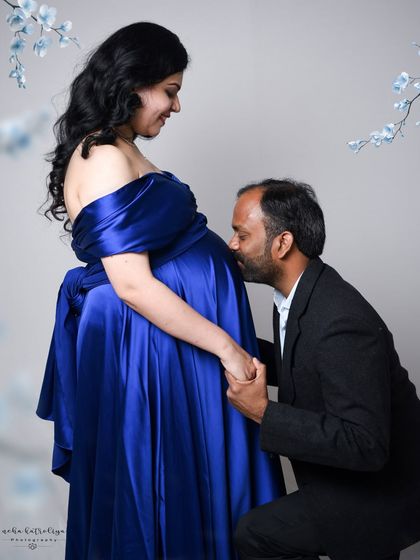 A classic and emotional pose for any maternity session. The father-to-be kneeling to kiss the baby bump is a beautiful expression of love and anticipation for their new arrival.