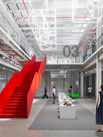 The interior of the 'ePositive' research center is conceived as an open and timeless hall for innovation. A bold, red staircase acts as a dynamic focal point in the industrial-style space, connecting levels and encouraging movement and collaboration in an honest, unpretentious setting.
