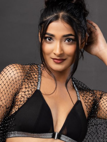 A friendly, smiling portrait of the model in the same outfit, showing her personality.