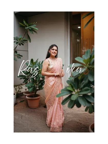 A beautiful solo portrait of our bride, Rasika, looking radiant in her elegant pink saree.