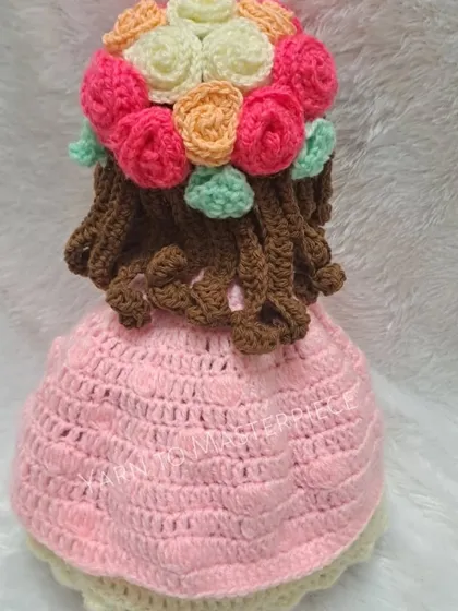 The back of the reversible doll, showing her beautiful brown crochet hair adorned with a crown of multi-colored roses. I pay close attention to every little detail.
