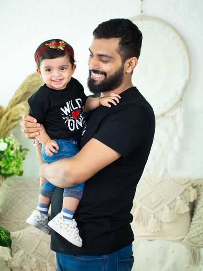 A proud dad holding his "Wild One." Capturing the special bond between a father and his daughter is always a joy.