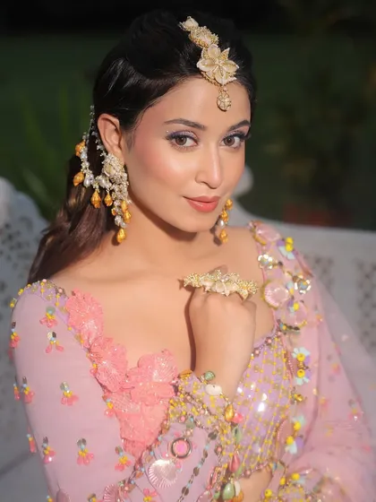 Another angle of this stunning Mehendi look. The makeup is playful yet polished, matching the intricate details of the Papa Don't Preach outfit.