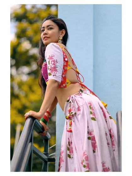 A different angle of the same colorful outfit, showing the back details of the blouse and the flow of the skirt.