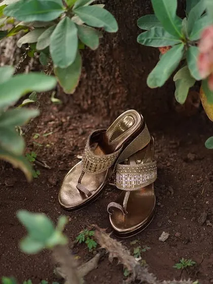 A detail shot of the bride's beautiful golden sandals, placed carefully in a natural setting. It's the small details that help tell the whole story.