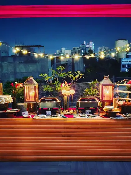 A full view of the rooftop party setup, showcasing the beautiful arrangement against the city lights. This image perfectly captures the magic of a high-end, urban event.