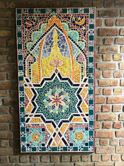 This vibrant mosaic tile art, with its intricate geometric patterns and rich colors, is a beautiful way to introduce spiritual and cultural elements into a space, creating a focal point that is full of meaning.