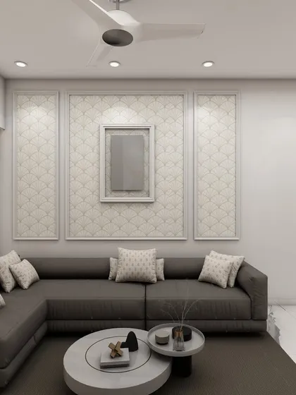 A minimalist living room with a large grey sectional sofa and a textured wall panel, creating a serene and sophisticated space for relaxation.