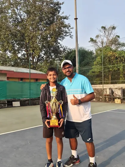Aarav Chhallani with his coach after winning the All India National Series Under 14 Doubles title in Mumbai.
