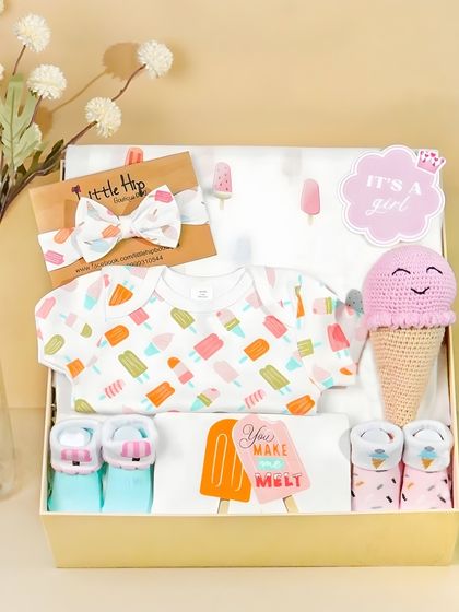 An 'It's a Girl' ice cream themed gift box. The shot includes a cute sign and coordinated items, making it a perfect, ready-made gift.