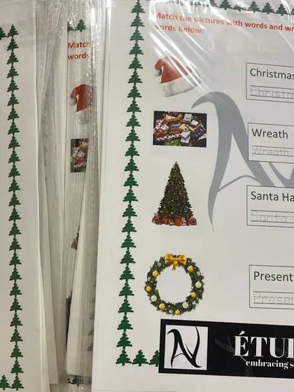 Preparing for the fun. These Christmas-themed activity sheets are all packed and ready for our Holly Carnival, where kids will match festive pictures with words.