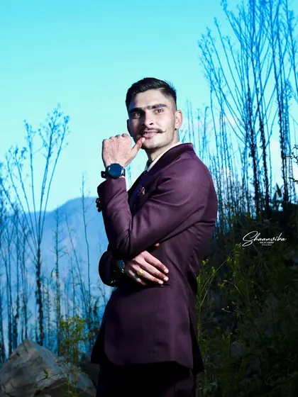 A stylish groom posing in the outdoors. The natural setting and his confident stance make for a very strong portrait.