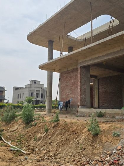 Another view of the Ludhiana construction site, highlighting the large open spaces and the relationship between the building and its surroundings. This is where our architectural vision begins to become a physical reality.