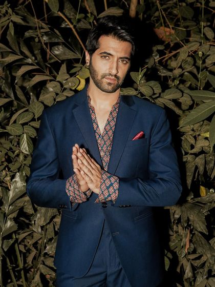 A centered, symmetrical pose against the dark leaves, creating a powerful and engaging final shot for the series.