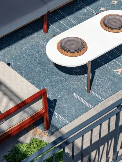 An expansive deck can transform an apartment into a home with a connection to the outdoors. For the Max128 show apartment, we designed this outdoor space as a true extension of the living area, perfect for quiet mornings or evening gatherings. The furniture is chosen for both comfort and durability, creating a low-maintenance urban oasis.