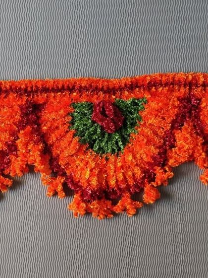 A fluffy and festive orange toran, perfect for celebrating the first day of Navratri.