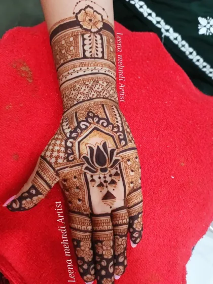 A classic Indian design with a large lotus motif at the center of the palm. The wrist cuff and finger details complete this timeless look for any festive occasion.