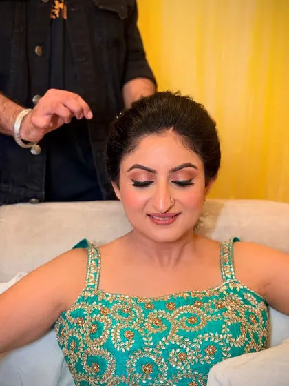 A behind-the-scenes shot of Shruti getting her hair done. The makeup is already looking perfect.