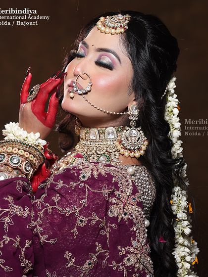 This side profile highlights the detailed hair work with fresh flowers (gajra) and the contouring that defines the bride's features beautifully.