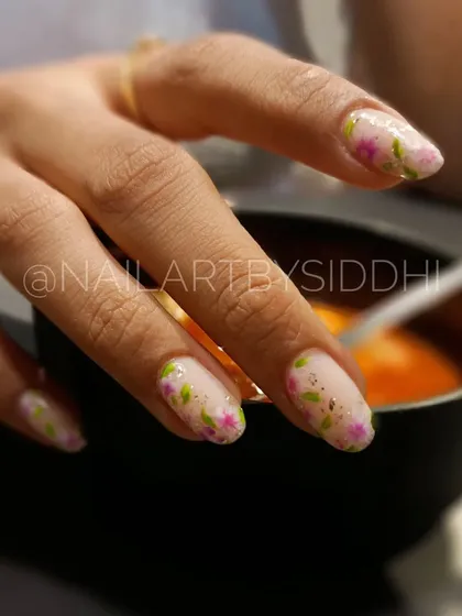 A delicate floral design with tiny pink flowers and green leaves on a sheer, shimmery base.
