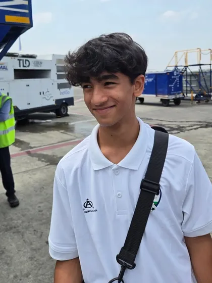A candid shot of one of our players on the airport tarmac, excited for the journey ahead.