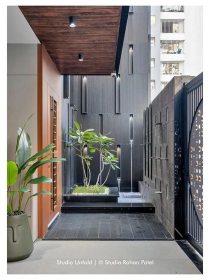 The complete entrance sequence of the 'Soham' project, showing the interplay of the gate, water feature, and main door.