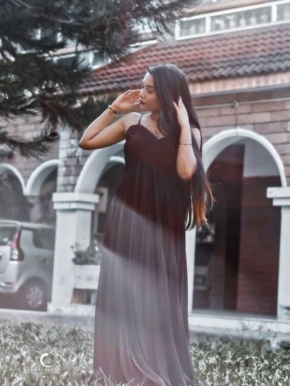 An artistic shot with a slow shutter speed, creating a beautiful motion blur effect. This portrait feels ethereal and dreamlike.