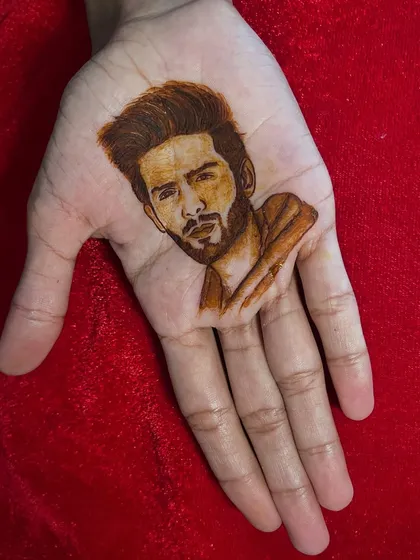 My portrait work extends to modern figures, like this henna portrait of Bollywood actor Kartik Aaryan. This demonstrates the precision and shading techniques I teach in my advanced figure work classes.